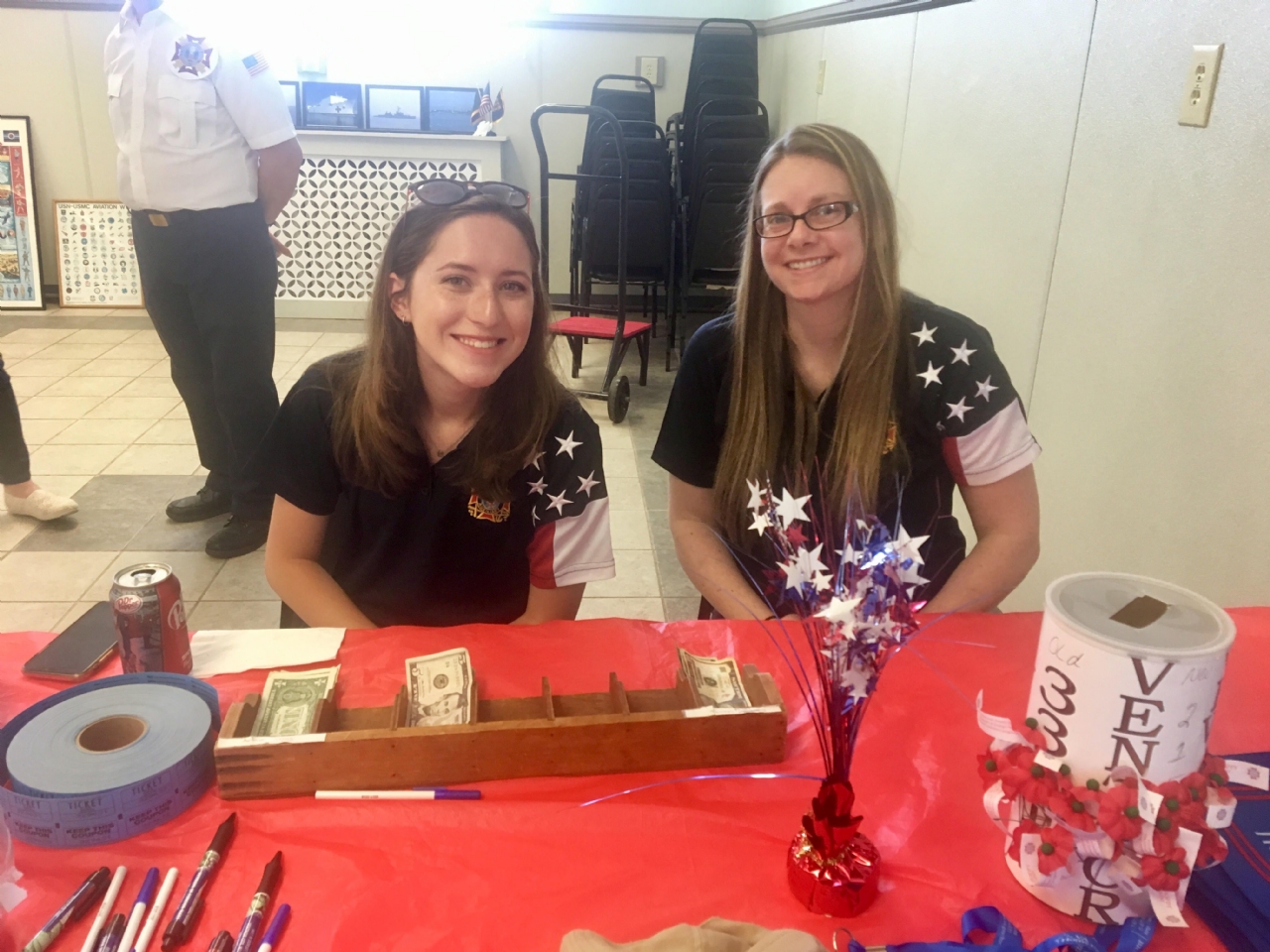 VFW Auxiliary Life Members Jennifer Wagener (R) and Rachel Shulte-Doody distribute Buddy Poppies and handle donations from a larger than usual attendance.